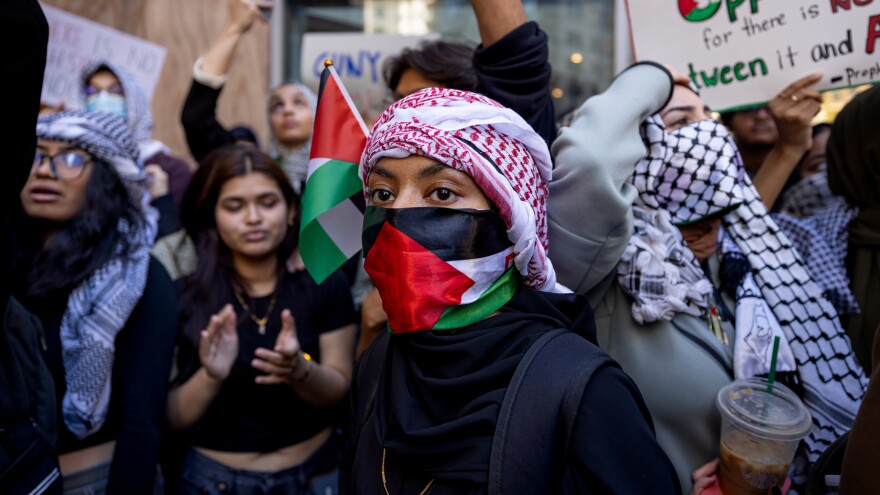 Students from Hunter College chant and hold up signs during a pro-Palestinian demonstration at the entrance of their campus in New York earlier this month.