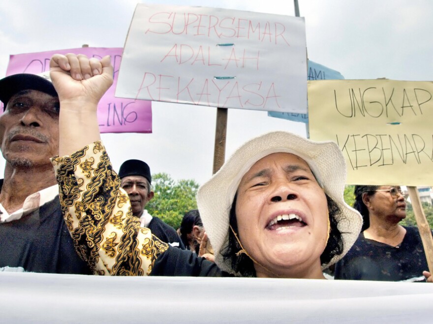 Indonesians protest outside the Presidential Palace in Jakarta, Sept. 28, 2005, calling for the government to bring former dictator Suharto to court for gross human rights abuse related to the deaths of alleged communists and communist sympathizers during the mid-1960s.