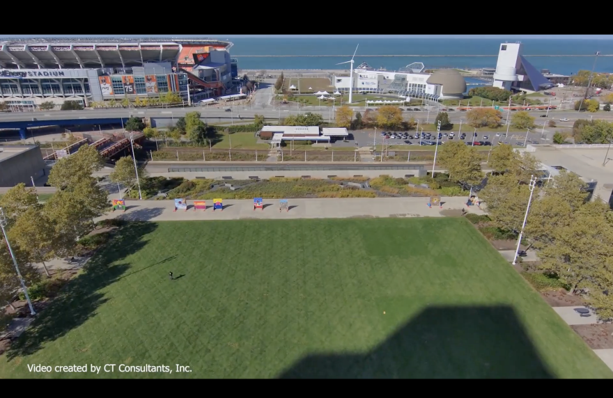 A still from a drone video shows where a proposed lakefront connector will be built by Cleveland to link downtown more firmly to Lake Erie and attractions at North Coast Harbor including the Great Lakes Science Center and the Rock and Roll Hall of Fame. The city-owned NFL stadium, left, will be replaced by new development.