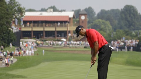Tiger Woods taps in his par putt on the first hole during the final round of the Bridgestone Invitational golf tournament at Firestone Country Club in Akron, Ohio, Sunday, Aug. 7, 2011. 