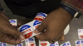 A poll worker sets out "I voted today" stickers at the St. Louis County Board Of Elections on Oct. 25.