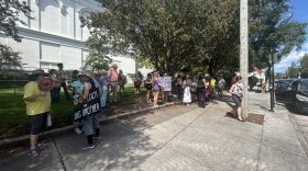 Protestors gathered next to Thalian Hall, across the street from the New Hanover County Courthouse, where county commissioners hold a meeting on Monday.