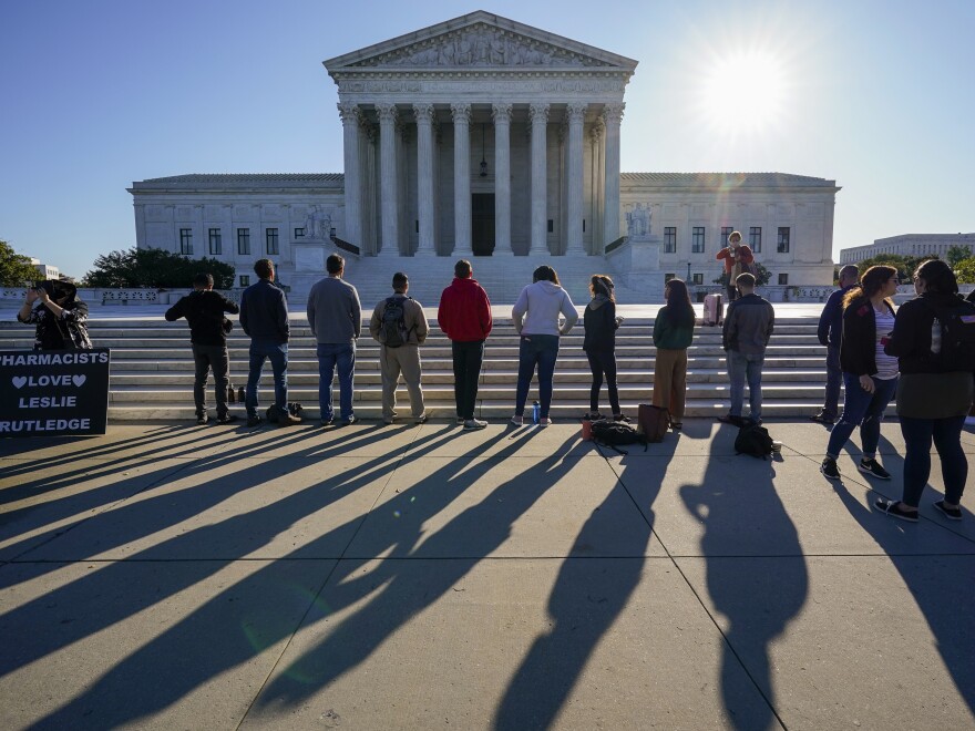 Anti-abortion rights activists demonstrate at the Supreme Court in Washington on Oct. 5. The court's new conservative supermajority puts the fate of <em>Roe v. Wade</em> in doubt.