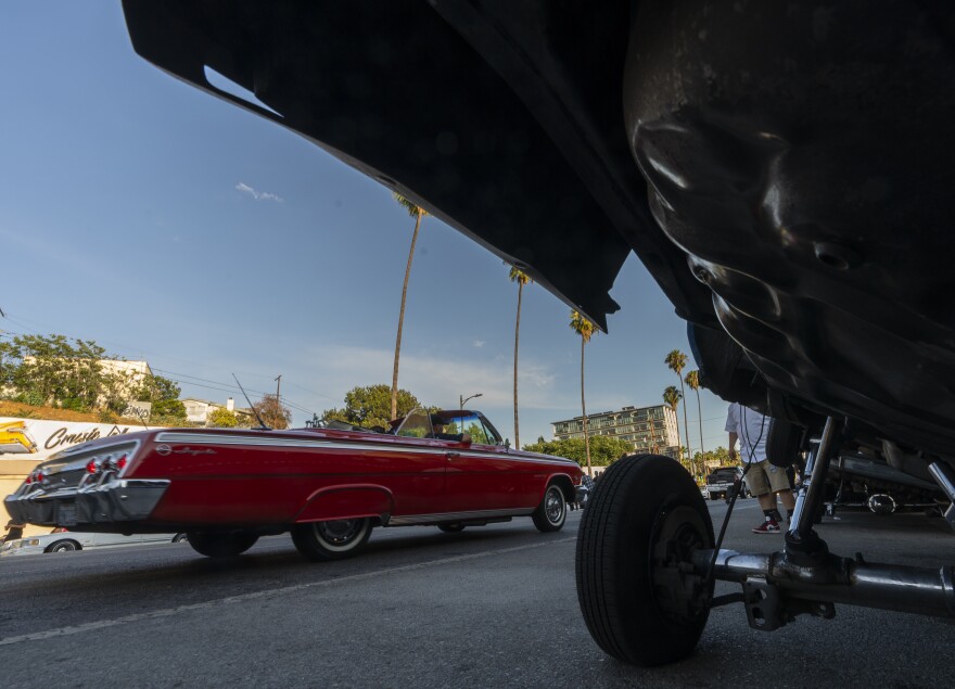 A convertible Lowrider vehicle cruises on Sunset Blvd., in the Echo Park neighborhood of Los Angeles late Sunday afternoon July 18, 2021.