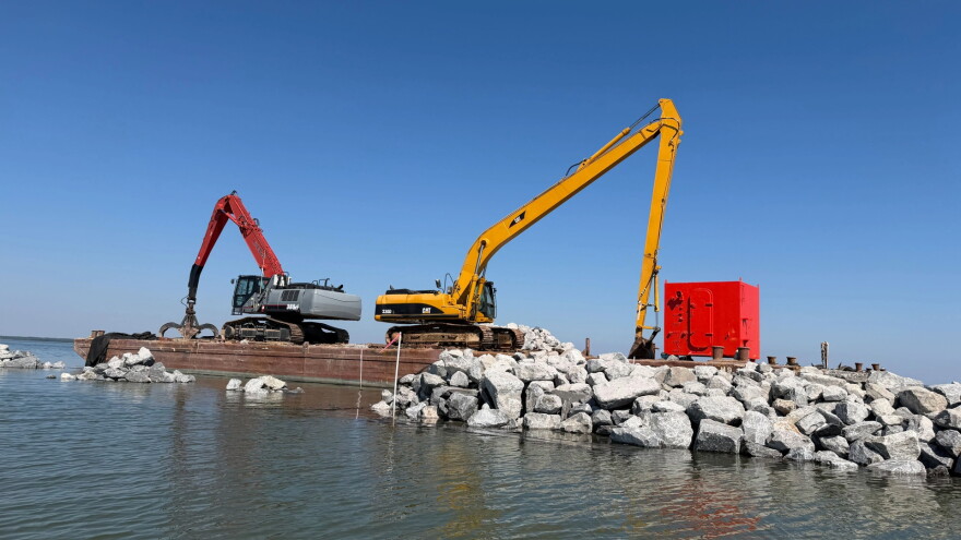 Engineers install rock breakwaters along the shoreline of Coffee Island.