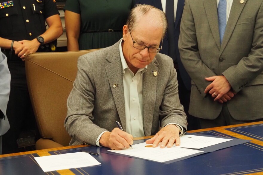 Indiana Gov. Mike Braun ceremonially signs legislation in his Statehouse office on Wednesday, May 28, 2025.