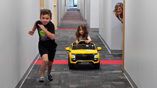 Matthew Gernhart 7, runs while his sister Abigail 5, drives her car in a race at King's as Dr. Elizabeth Dixon watches.