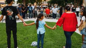 Members of the community gather at the City of Uvalde Town Square for a prayer vigil in the wake of a mass shooting at Robb Elementary School.