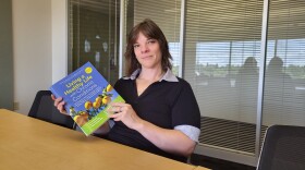 photo of Dallas Abraham holding the book "Living A Healthy Life"