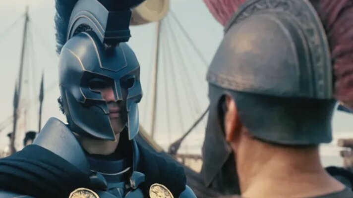Two men looking at each other. They are dressed in ancient Greek armor with helmets.