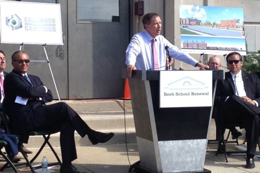 Gov. John Kasich speaks next to Columbus Mayor Michael Coleman, left. (Andy Chow / Ohio Public Radio)