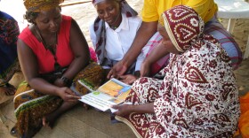 A group of traditional birth attendants took part in a yearlong trial of misoprostol in rural areas of Mozambique. Here they review a booklet on proper administration of the pills.