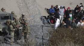 U.S. military stop migrants from crossing into El Paso, Texas, seen from Ciudad Juarez, Mexico. (Christian Chavez/AP)
