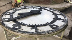 Workers remove this historic clock from the Town Center garage that has been there since the early 1970s.