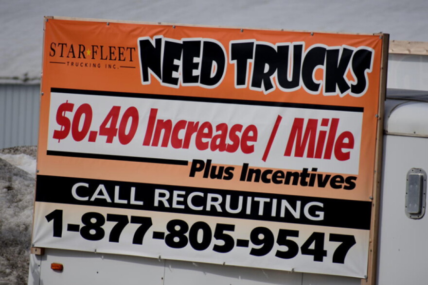 A sign from a trucking company in Nappanee, Indiana, recruits truckers. In some industries, like trucking, worker shortages were exacerbated by the pandemic.