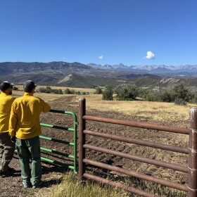 Brody Wilson and Kevin Sweeney survey a fire line from the side of Owl Creek Pass. The dirt was in a 3 foot tall pile on one side, but has been replaced as a part of the work to rehabilitate public and private lands damaged during the fire.
