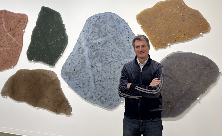 Director of the Kimball Art Center, Aldy Milliken, in one of the organization's gallery spaces on April 3, 2026. The Kimball is planning to nearly double its footprint when it moves into a new space by 2031. Behind Milliken is "Touchstone," a work by sculptor Kellie Bornhoft.