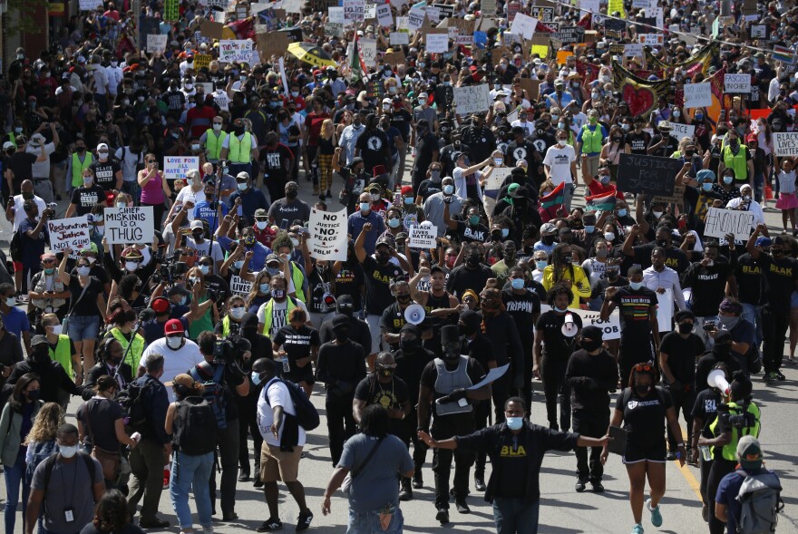 Protesters march in a Black Lives Matter march for Jacob Blake in Kenosha, WI.