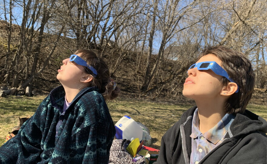 Maggie Sullivan (left) and Marty Rothenberg (right) viewing the total solar eclipse in Canaan, Vermont.