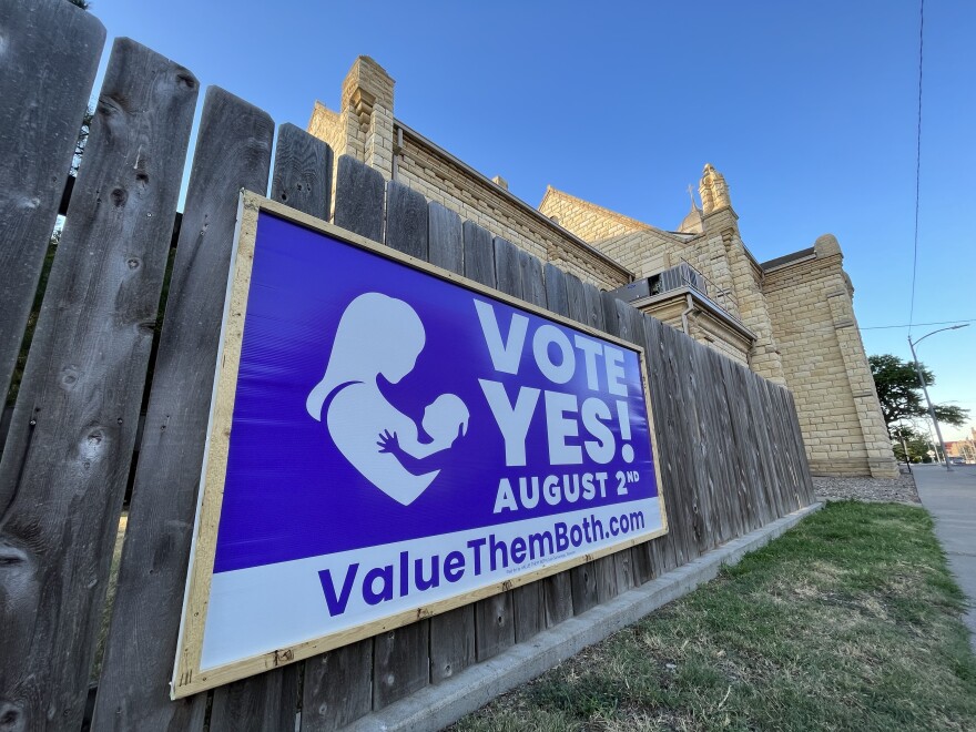 A sign supporting the amendment to the state constitution to remove abortion rights in Kansas hangs outside of St. Joseph's Catholic Church in Hays. Many churches across the state have hung the signs in support of the amendment.