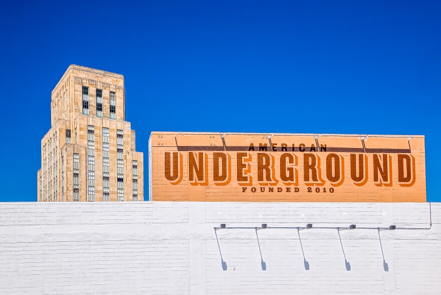 A shot from the top of the Corcoran Street parking garage.  The American Underground sign is visible along with the 21c Hotel to the left.