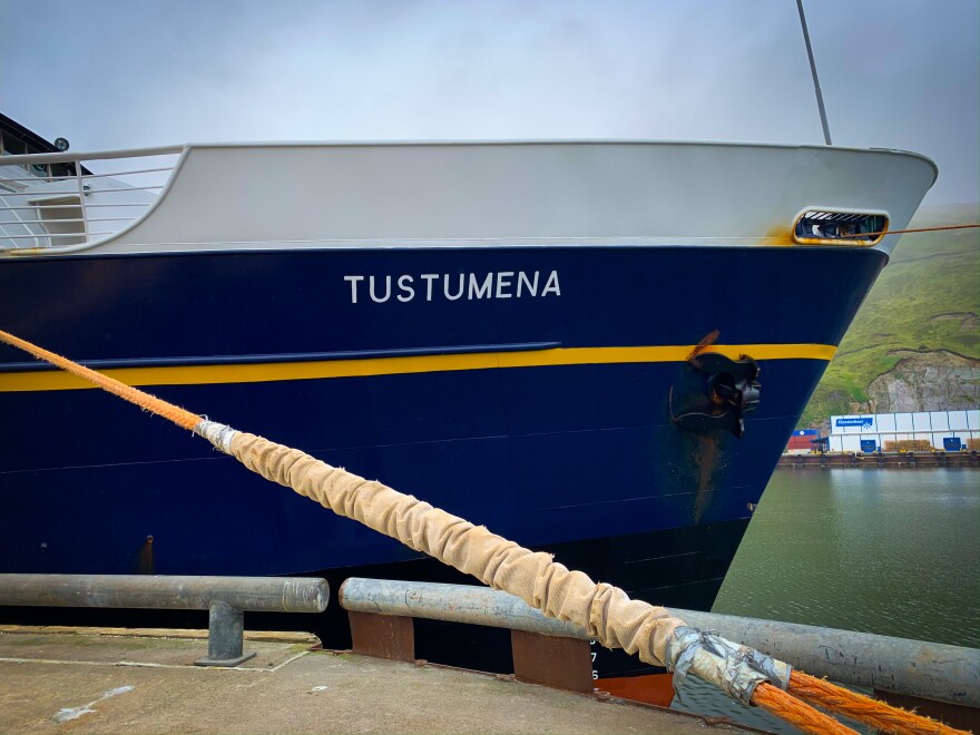 A blue bow with a yellow stripe at a dock