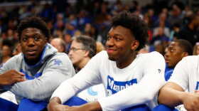 Memphis Tigers center James Wiseman smiles from the bench as he waits on a decision from the NCAA concerning his eligibility, while his teammates play against Alcorn State at the FedExForum on Saturday, Nov. 16, 2019.