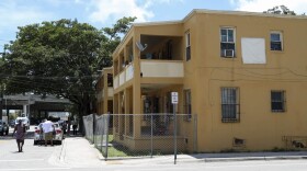 People stand in front of an apartment building where a 10-year-old boy that died of a fentanyl overdose last month lived, in Miami, Fla., Tuesday, July 18, 2017. (Mario Houben/AP)