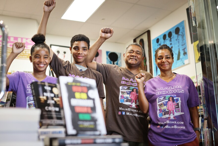 Malik Muhammad runs his Los Angeles bookstore with his wife, April, and children Mecca (left) and Zahir.