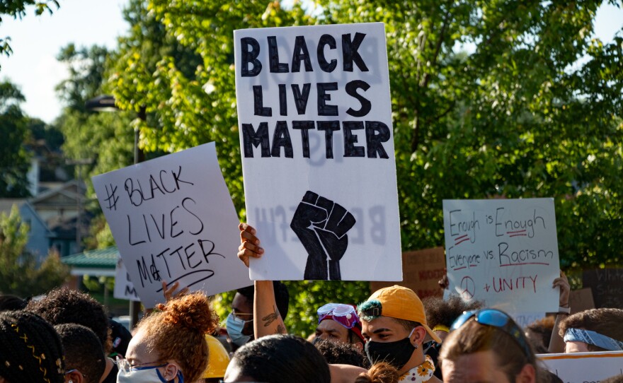 Demonstrators in Des Moines hold signs supporting the Black Lives Matter movement at a march on June 3, 2020. 