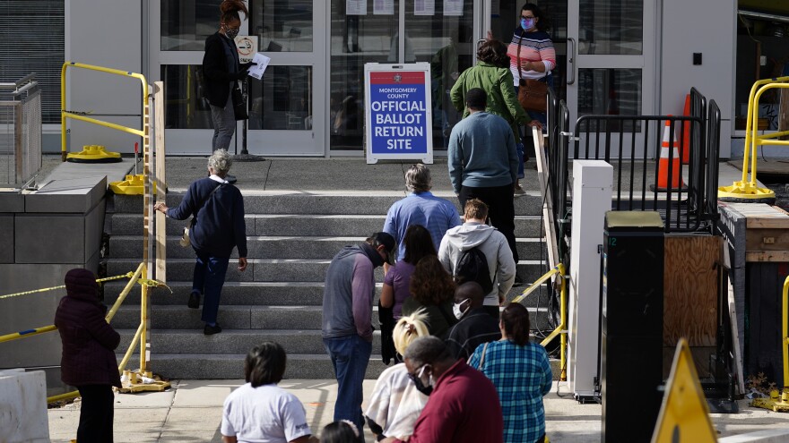 Residents line up outside the Montgomery County voter services office on Oct. 19, 2020, in Norristown, Pa. Last year, Joe Biden ran up the vote margins in Philadelphia's four Collar Counties, which include Montgomery. [Matt Slocum / AP]