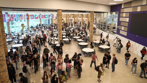 students gathering in a open High School cafeteria.