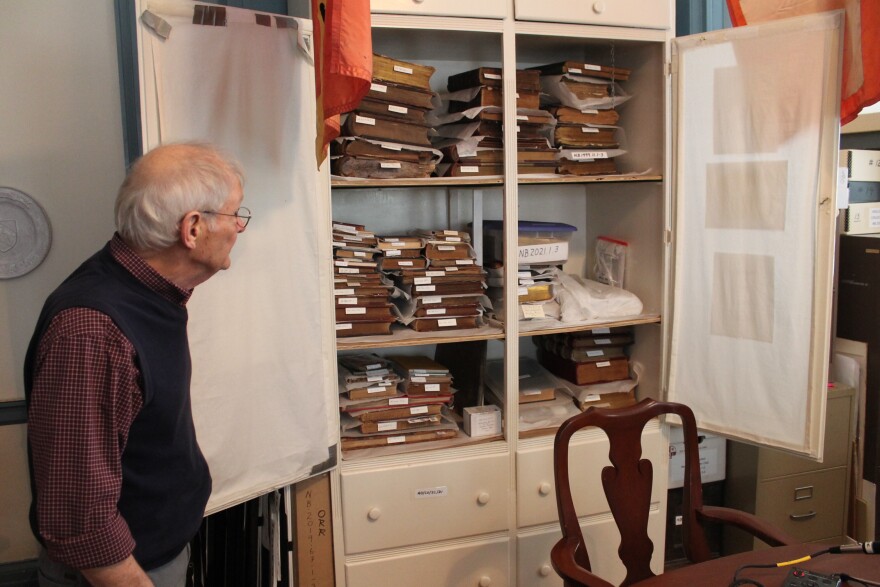 Jim Hodges, a curator at the New Bern Historical Society, studies the collection of historical books and documents collected by the historical society, including the John Oliver ledger, which recorded the infamous Stanly-Spaight duel.