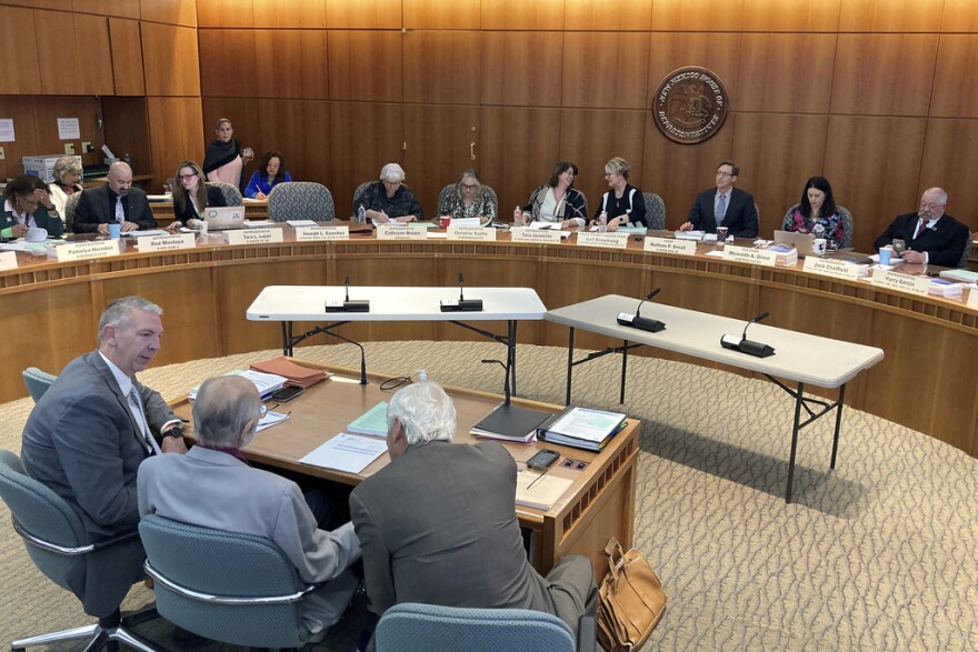 FILE - New Mexico legislative staff prepare to present details of a massive annual spending plan to a panel of state House legislators on Feb. 15, 2023, in Santa Fe, N.M. The New Mexico Senate on Sunday, March 12, 2023, endorsed the nearly $9.6 billion budget to fund public salaries, shore up rural health care networks and expand no-pay day care and college. (AP Photo/Morgan Lee, File)