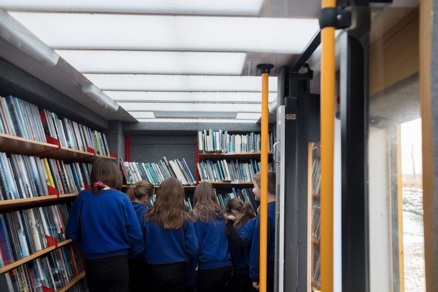 Students at the Sgoil an Taobh Siar primary school in Barvas choose books from the mobile library van. Most school libraries have limited and outdated stock, and the mobile van provides more options.