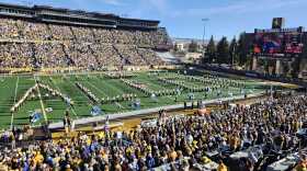 Members of the Western Thunder Marching Band spell out Josh Allen's last name in front of packed stands.