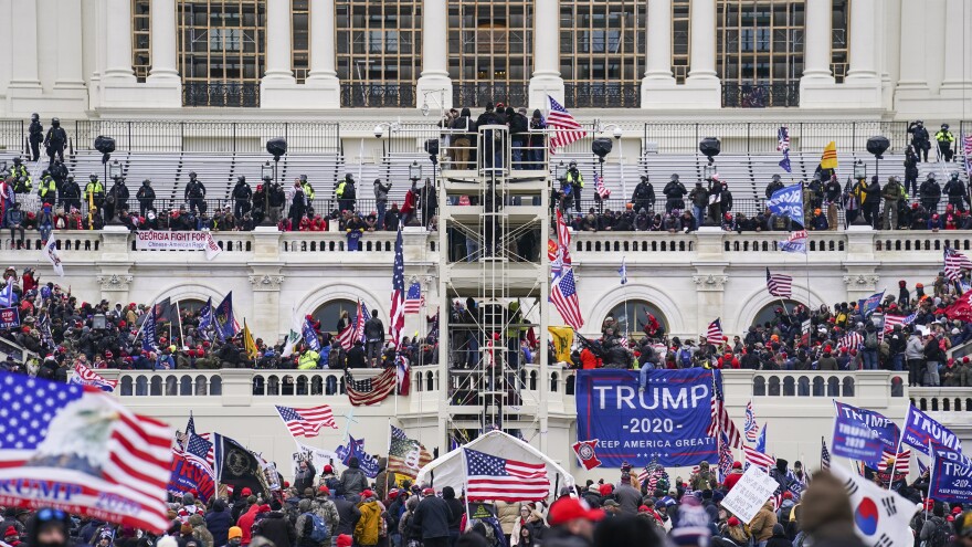 Insurrectionists loyal to former President Donald Trump breach the U.S. Capitol in Washington on Jan. 6. Prosecutors have secured the first guilty plea in a conspiracy case brought against members of the Oath Keepers extremist group in the attack.