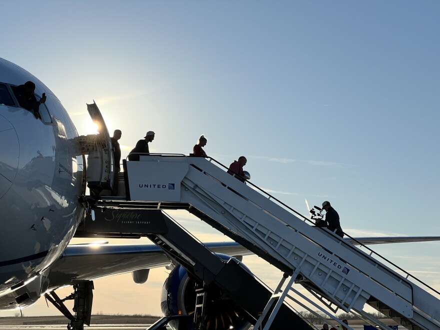 Kansas City Chiefs coach Andy Reid steps off a plane at the Kansas City airport with the Vince Lombardi trophy on Feb. 13, 2023, following the team's Super Bowl win.