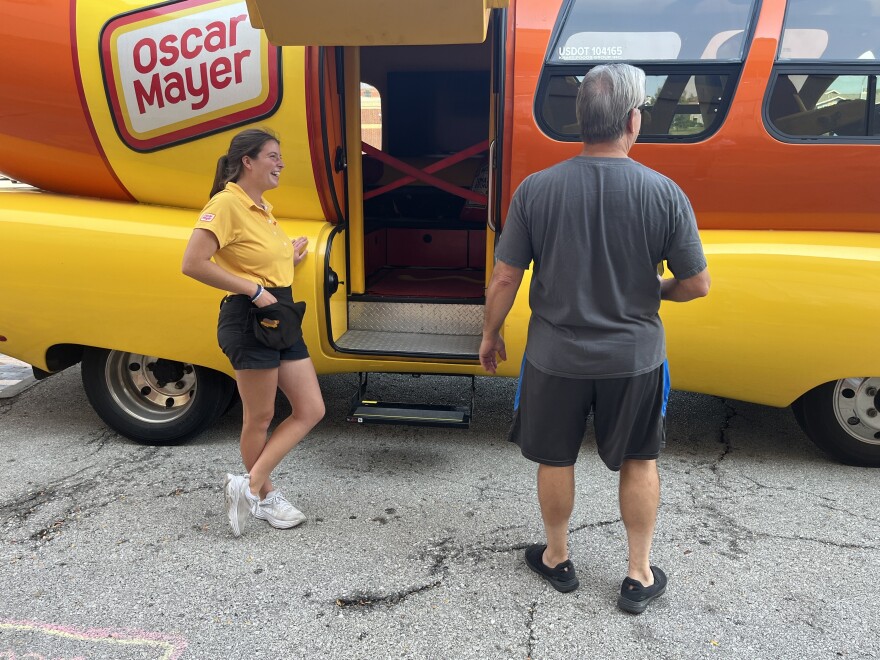 Chili Cheese MC shows off the Wienermobile as it's parked in front of a Northland Hy-Vee. 