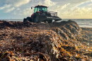 A bulldozer scoops up sargassum on Key Biscayne in 2022.