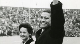 Clifton Wharton Jr. and his wife Delores waving to a large crowd
