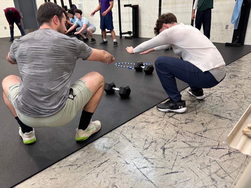 Coach Austin Haines shows correct form to a young participant of Expanding Horizons at the Circleville Juvenile Corrections Facility.