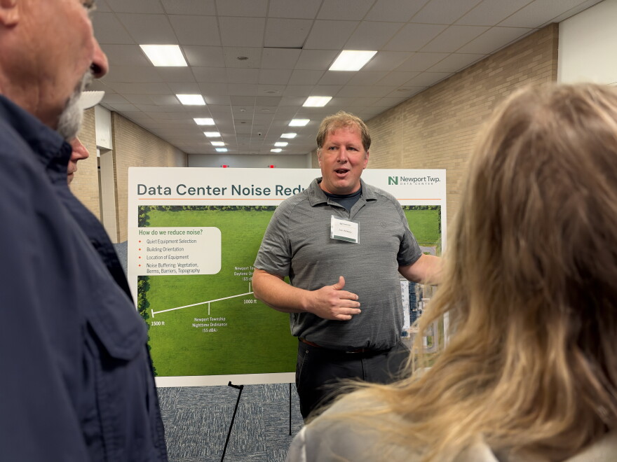 An official with the Newport Twp. Data Center project talks to residents during the open house.