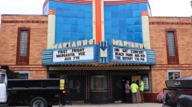 A shot of the outside of the Marianne Theater. A Bellevue Public Works truck sits outside, and two workers talk with the mayor. The city does some mild renovations to keep the building from completely deteriorating. 