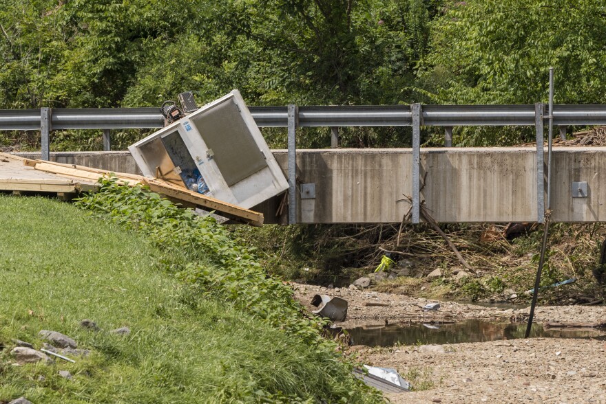 An ice cooler sits wedeged into a bridge along Fish Creek in Hundred, Wetzel County, W.Va., after flash floods hit the area early on July 29, 2017.