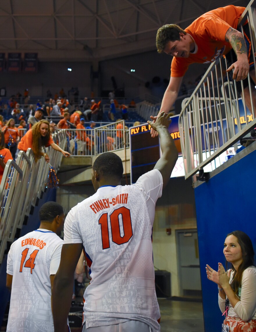 Florida senior Dorian Finney-Smith (10) and teammate Lexx Edwards (14) exit the O'Dome for their final time after suffering a 88-79 loss to Kentucky. (Greenberry Taylor/WUFT News)