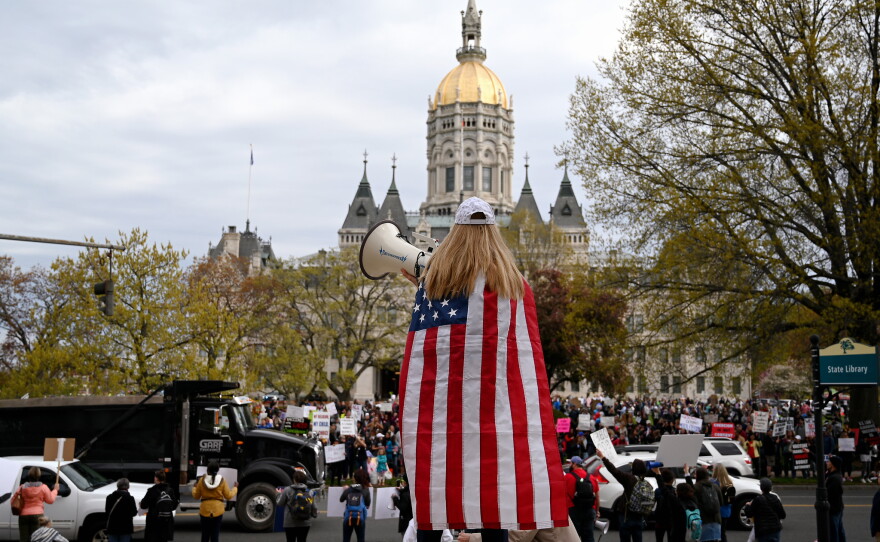 Protesters gather at the state Capitol on April 27, 2021, to rally against a bill that would remove the religious exemption from school vaccination requirements.