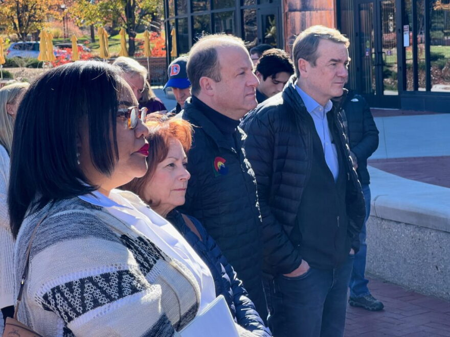 From left, Danielle Young-Kombo, deputy political director for Gov. Jared Polis, stands with Rep. Diana DeGette (second from left), Gov. Jared Polis, Sen. Michael Bennet and, in blue hat in background, Rep. Jason Crow, at a Nov. 7 rally at the University of Denver.
