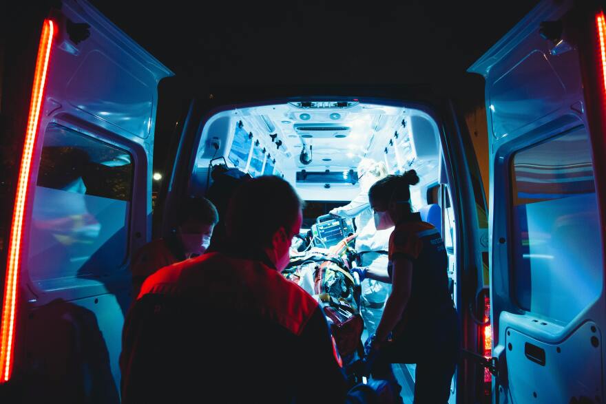 paramedics standing outside ambulance doors