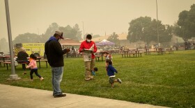  Families at the Jackson County Expo read the news on Sept. 9, 2020, the day after the Almeda Fire destroyed thousands of homes.